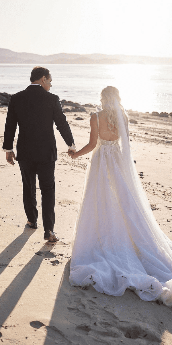 open back wedding dresses bride and groom on the beach