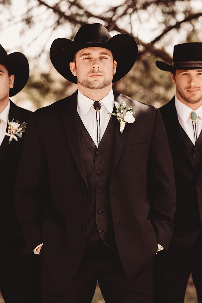groomsmen attire black with hats cowboy style native roamnig