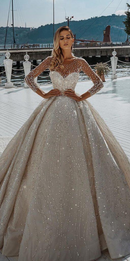 https://weddingdressesguide.com/wp-content/uploads/2020/04/illusion-long-sleeve-wedding-dresses-ball-gown-sweetheart-neckline-sequins-saidmhamadofficial-512x1024.jpg